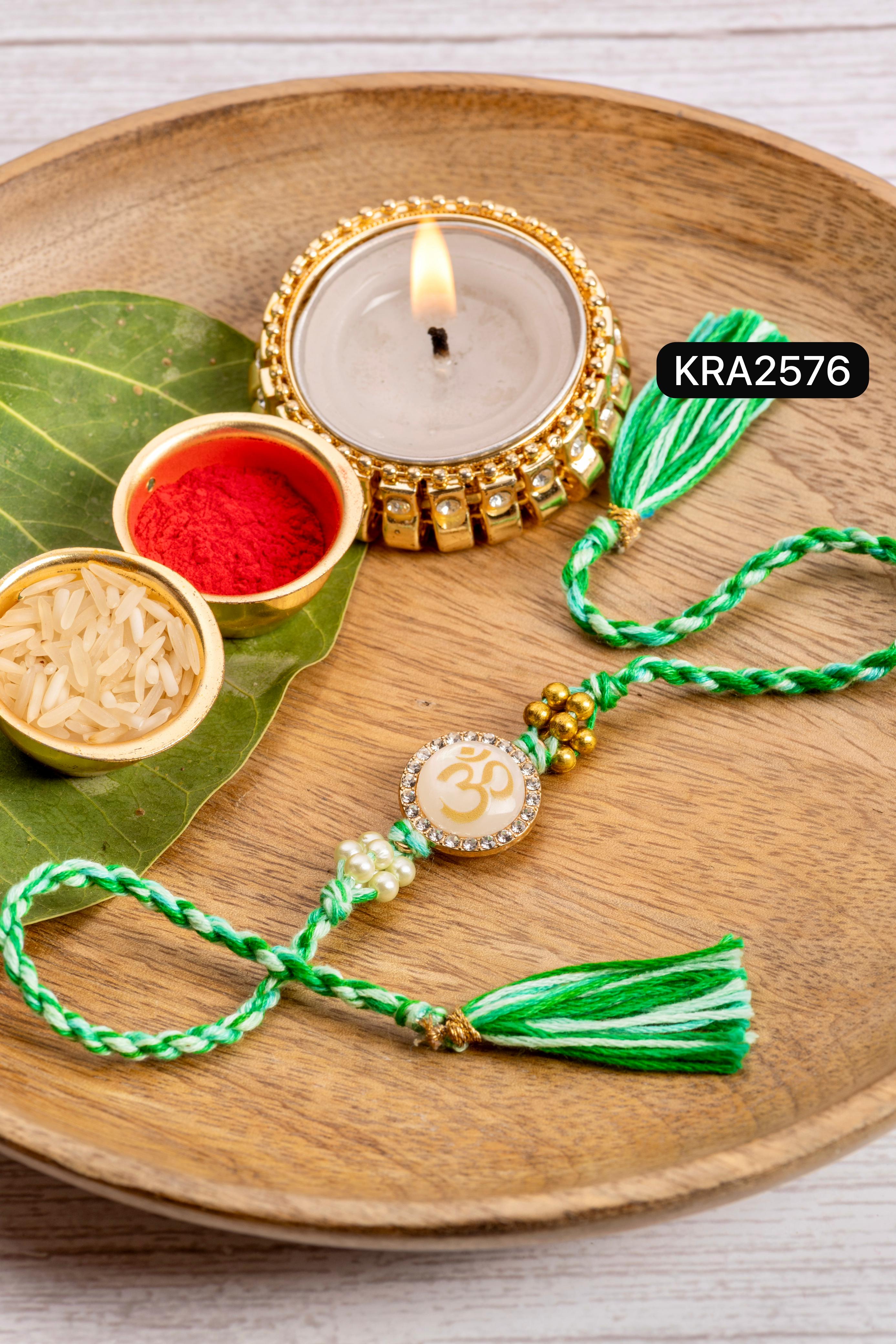 Monalisa Stone OM Embellished Hand Braided Rakhi With Tassels (KRA2576)