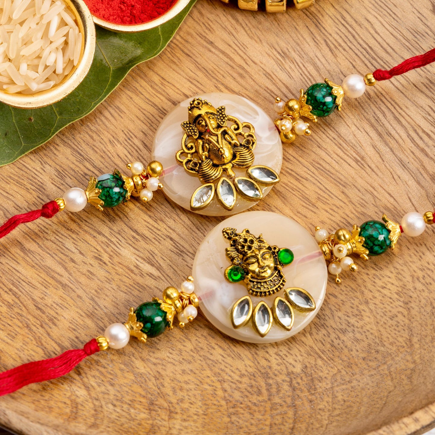 Ganpati Ji & Srinath Ji Metal Rakhi With Mother Of Pearl Base (KRA2555)