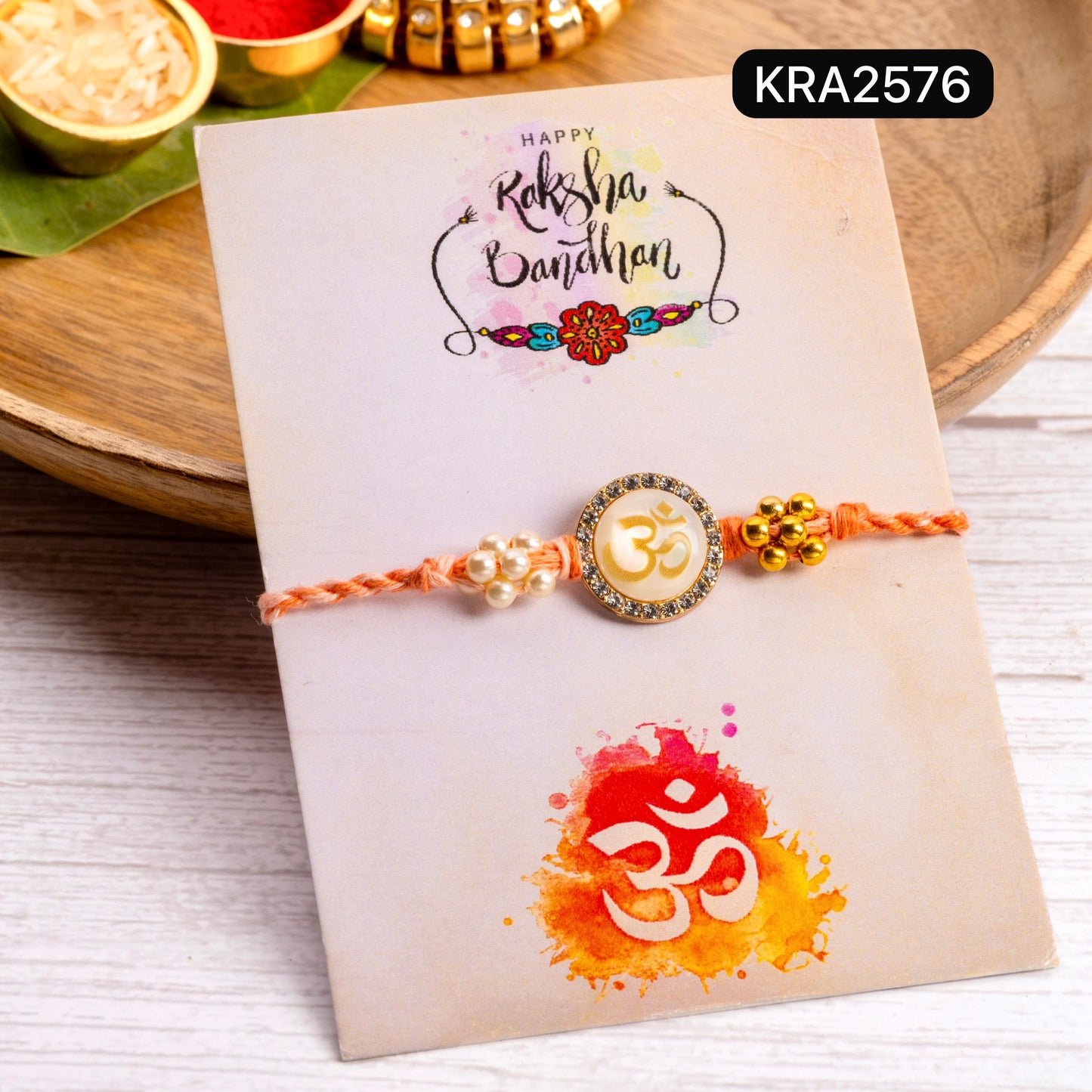 Monalisa Stone OM Embellished Hand Braided Rakhi With Tassels (KRA2576)